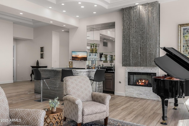 13621 E Aster Dr, Scottsdale, AZ 85259 - sitting room featuring wet bar, a fireplace, visible vents, light wood-style floors, and recessed lighting