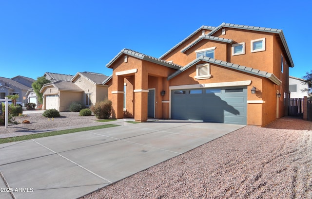 view of front of house featuring a tile roof, stucco siding, concrete driveway, an attached garage, and a residential view