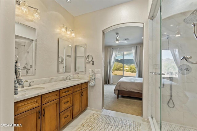 bathroom with ceiling fan, tile patterned flooring, vanity, and a shower with shower door