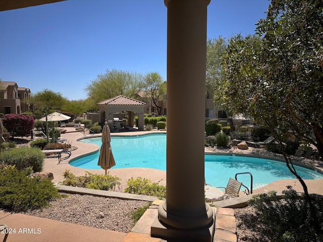 view of swimming pool with a gazebo and a patio