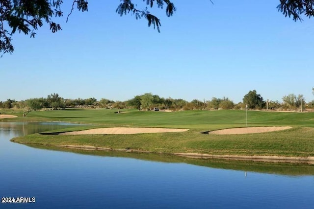 view of community with a lawn and a water view