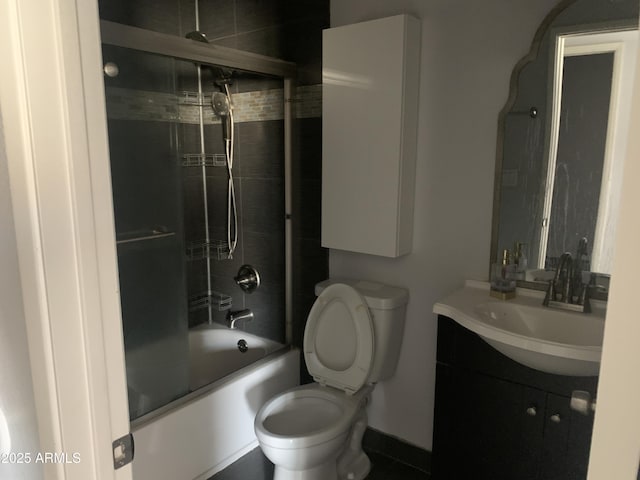 full bathroom featuring vanity, toilet, and combined bath / shower with glass door