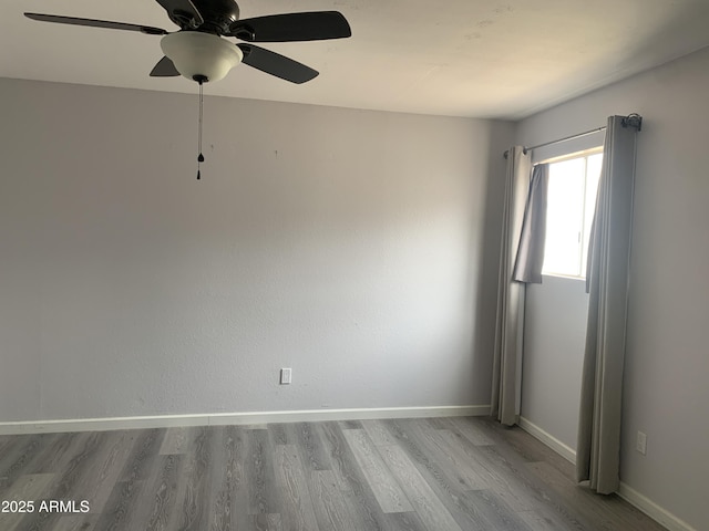 unfurnished room featuring ceiling fan and light wood-type flooring