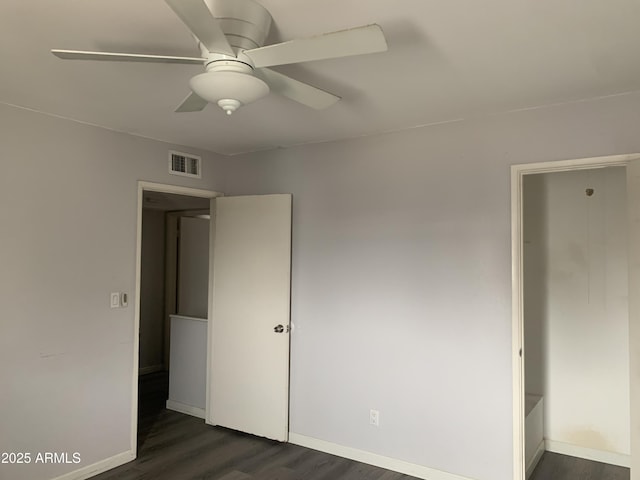 unfurnished bedroom featuring ceiling fan and dark hardwood / wood-style floors