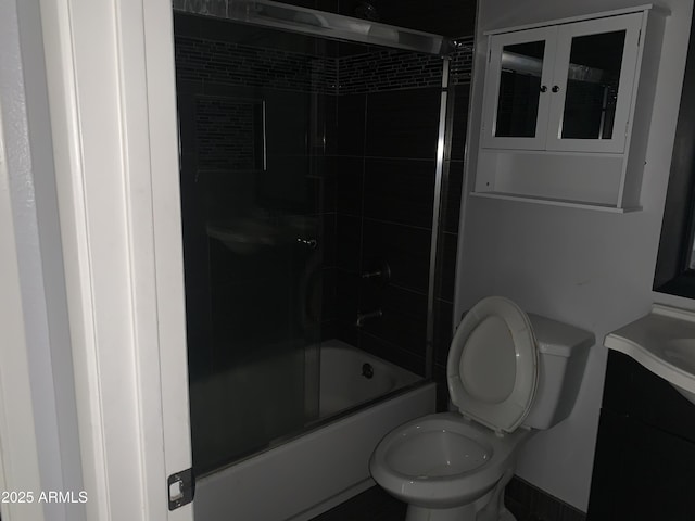 full bathroom with vanity, shower / bath combination with glass door, and toilet