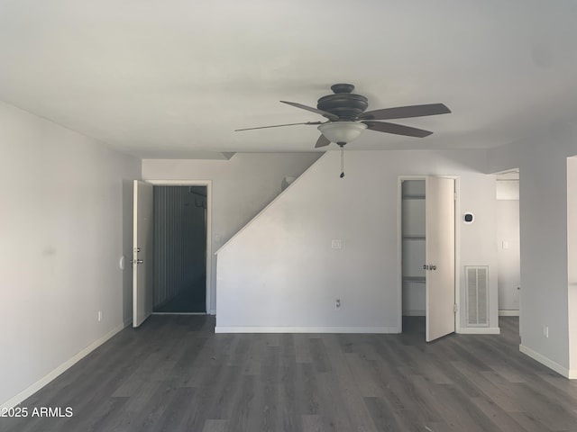 unfurnished living room with ceiling fan and dark hardwood / wood-style flooring