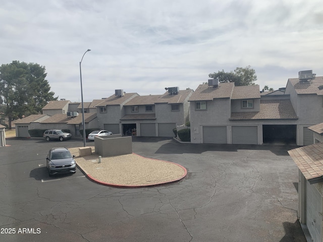 view of front of house with central AC and a garage