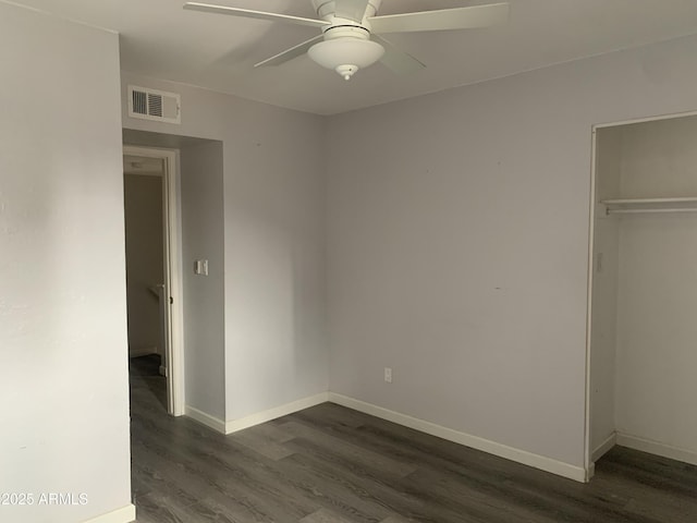 unfurnished bedroom with a closet, dark hardwood / wood-style floors, and ceiling fan