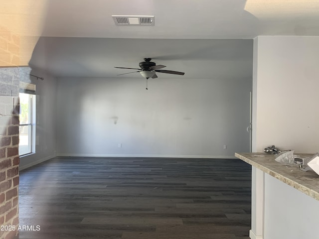 spare room featuring ceiling fan and dark hardwood / wood-style flooring