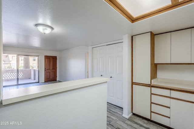 kitchen with white cabinetry and light wood-type flooring