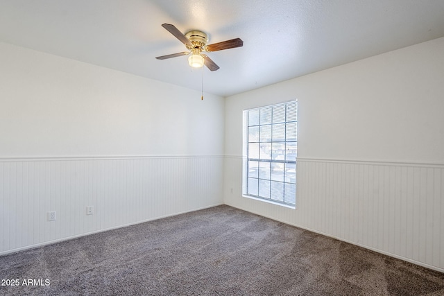 empty room featuring carpet floors and ceiling fan