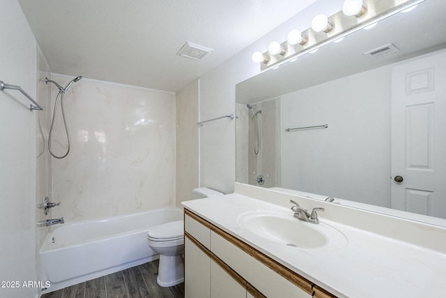 full bathroom featuring vanity, hardwood / wood-style floors, toilet, and washtub / shower combination