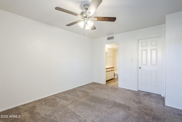 unfurnished bedroom featuring connected bathroom, light colored carpet, and ceiling fan