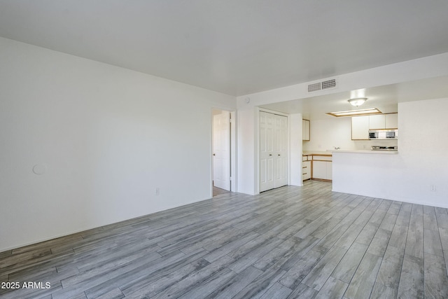 unfurnished living room with light wood-type flooring