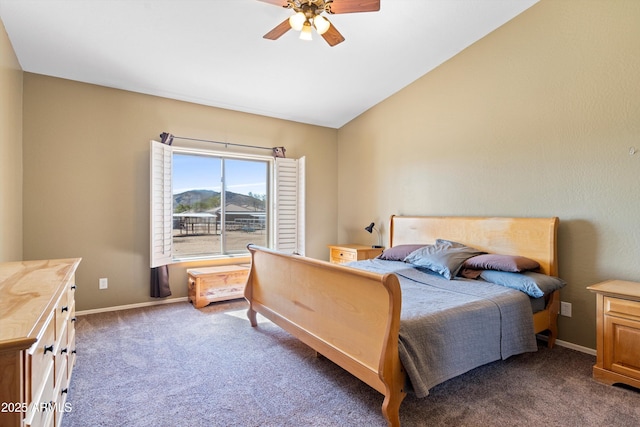 bedroom with vaulted ceiling, a ceiling fan, baseboards, and dark colored carpet