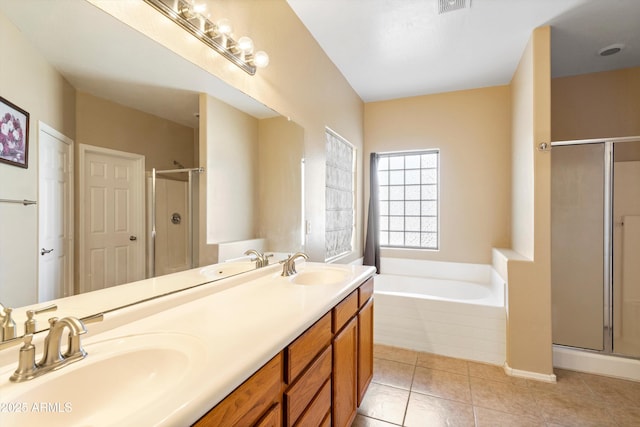 bathroom featuring a stall shower, a garden tub, and a sink