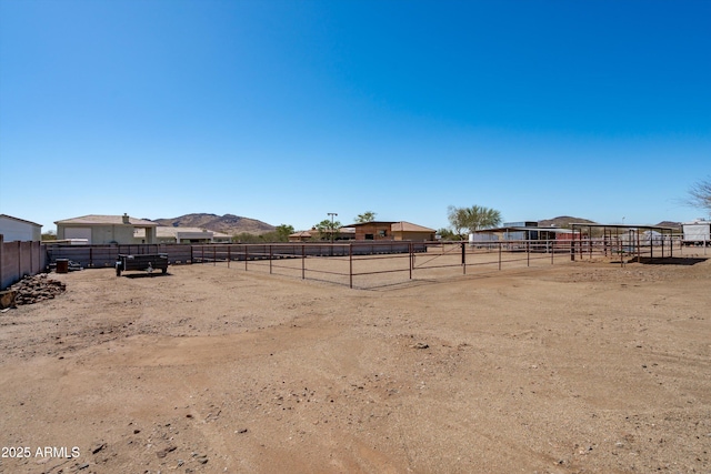 view of yard with an enclosed area and a mountain view