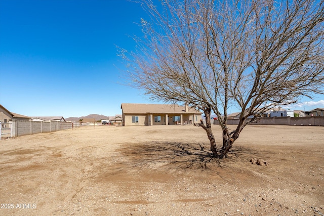 view of front of home featuring stucco siding and fence