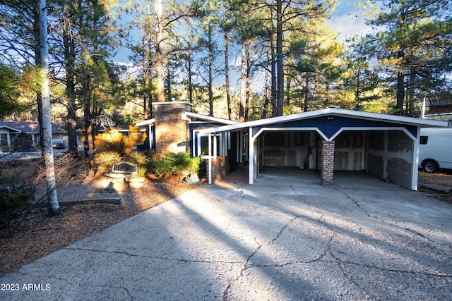 view of property exterior with concrete driveway and brick siding