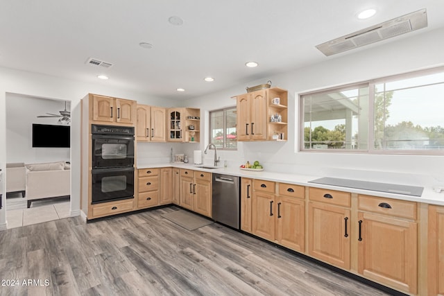 kitchen with ceiling fan, sink, light hardwood / wood-style floors, light brown cabinetry, and black appliances