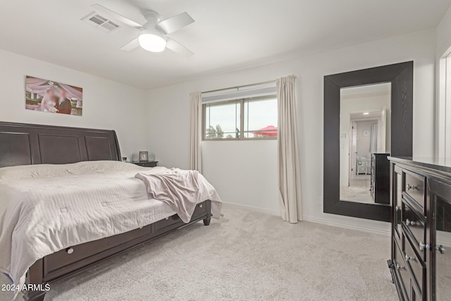 bedroom with ceiling fan and light carpet