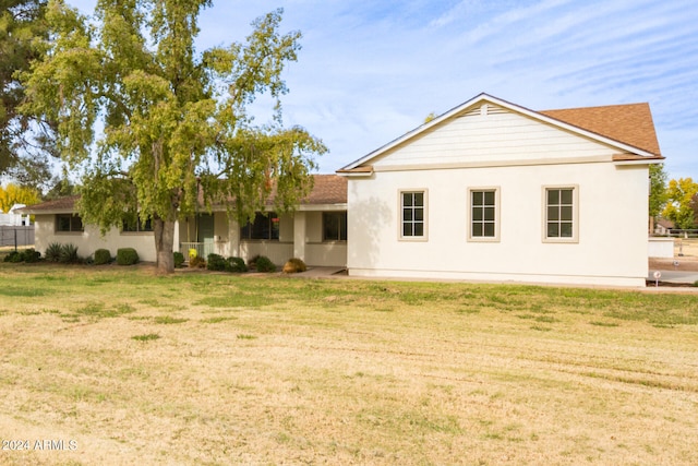 rear view of house with a yard