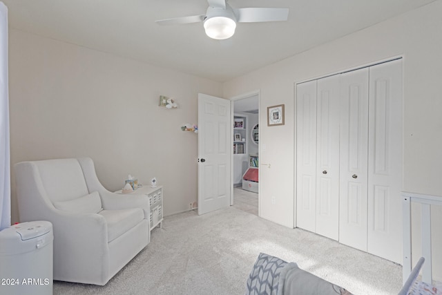 sitting room with ceiling fan and light colored carpet