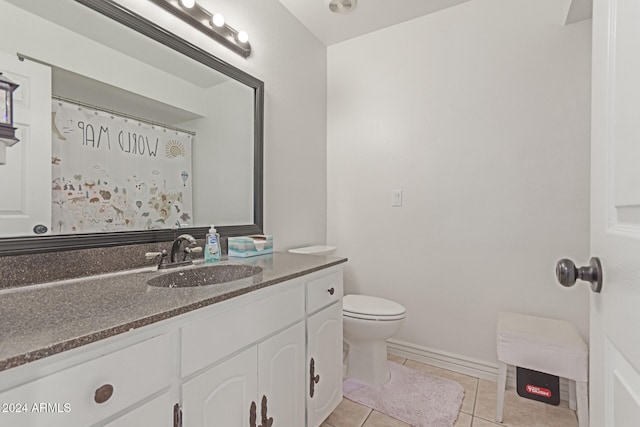 bathroom featuring tile patterned flooring, vanity, and toilet