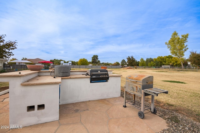 view of patio / terrace featuring a grill and exterior kitchen