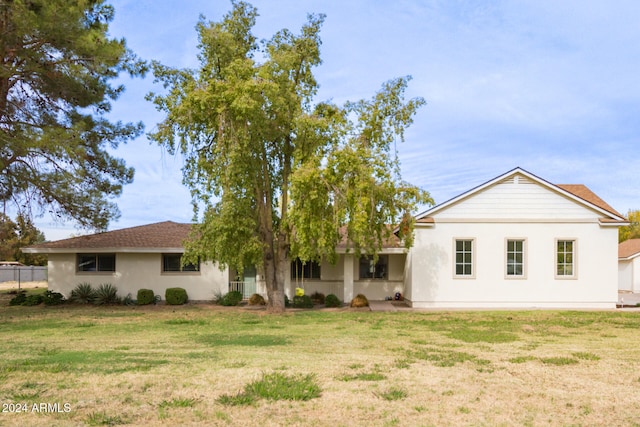 back of house with a lawn