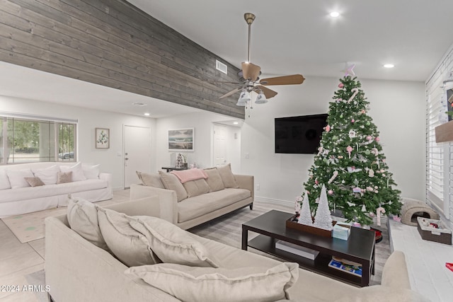 living room with ceiling fan and vaulted ceiling