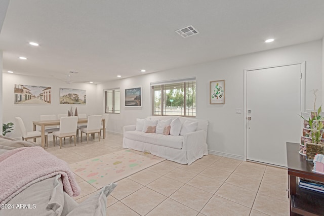 tiled living room featuring ceiling fan