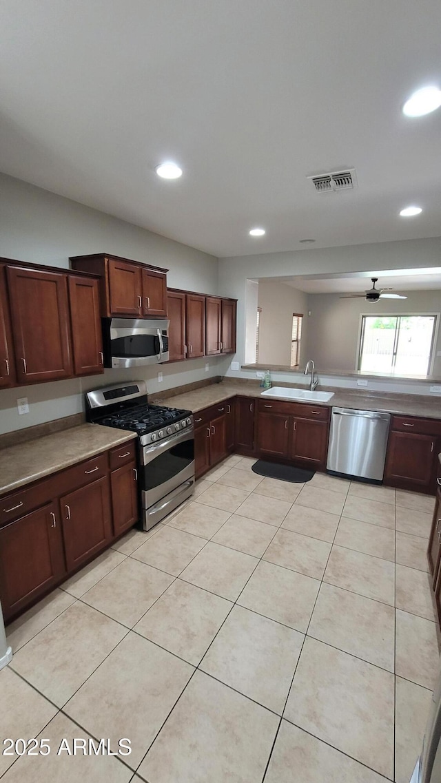 kitchen with stainless steel appliances, a sink, a ceiling fan, recessed lighting, and light tile patterned floors