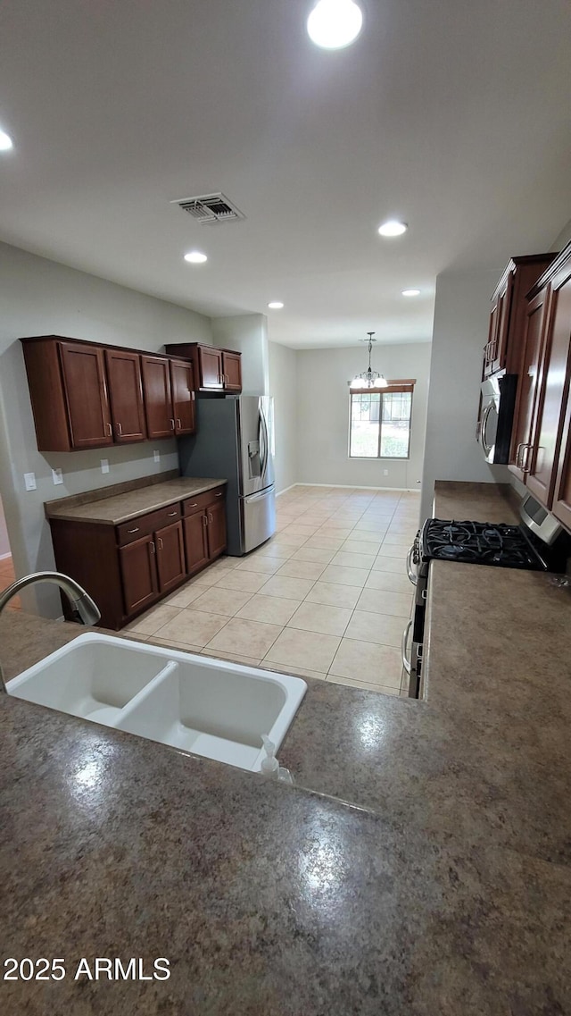 kitchen with a sink, stainless steel appliances, and recessed lighting