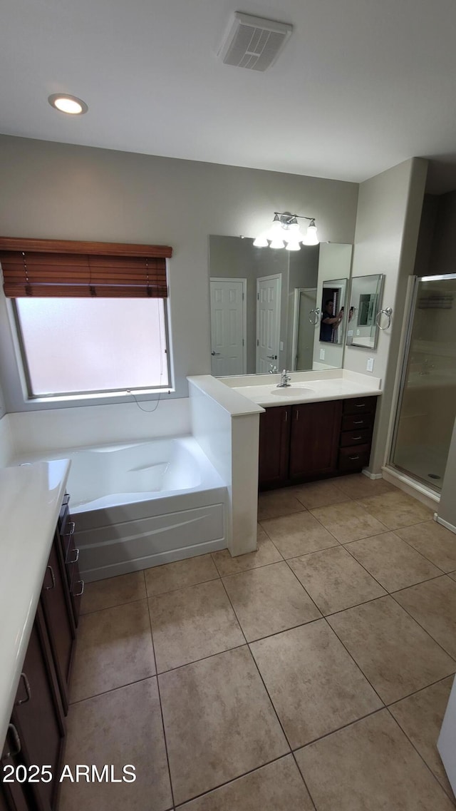 bathroom with vanity, tile patterned flooring, a shower stall, a garden tub, and recessed lighting
