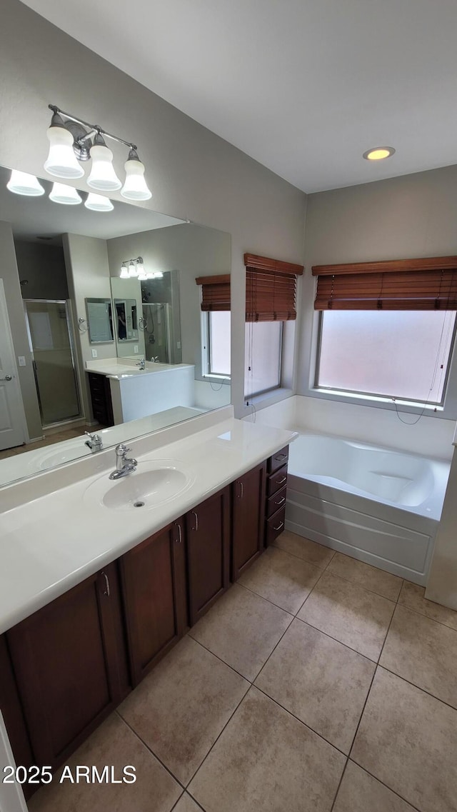 full bathroom with a shower stall, healthy amount of natural light, tile patterned floors, a bath, and recessed lighting