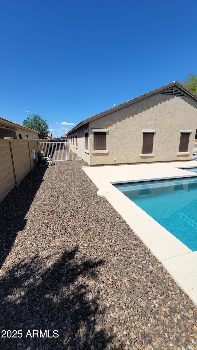 view of swimming pool with a fenced backyard