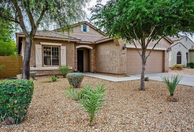 traditional-style home with stucco siding, a garage, concrete driveway, a tile roof, and fence
