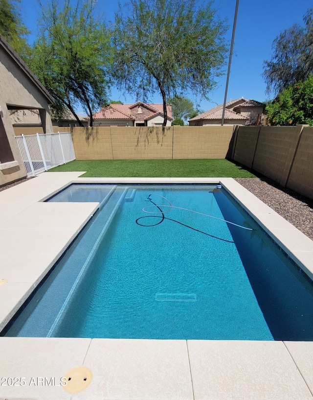 view of swimming pool featuring a fenced backyard