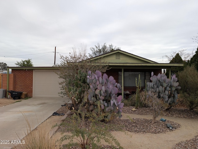 view of front of property featuring driveway and brick siding