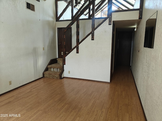 5463 E Roberts Dr, Globe, AZ 85501 - unfurnished living room featuring wood finished floors, stairs, and baseboards