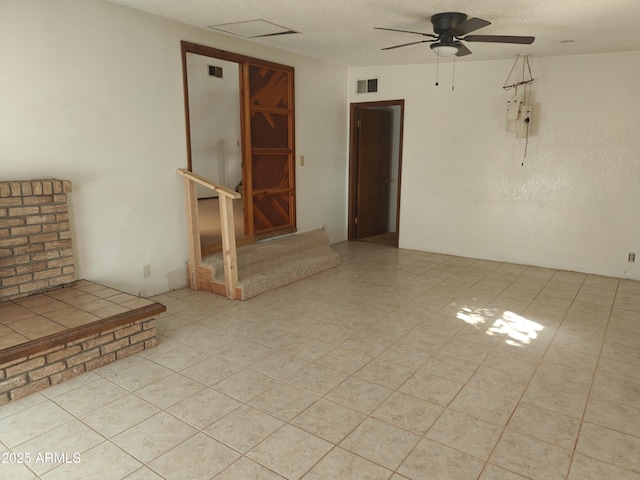5463 E Roberts Dr, Globe, AZ 85501 - unfurnished room featuring a ceiling fan, a textured ceiling, and stairs