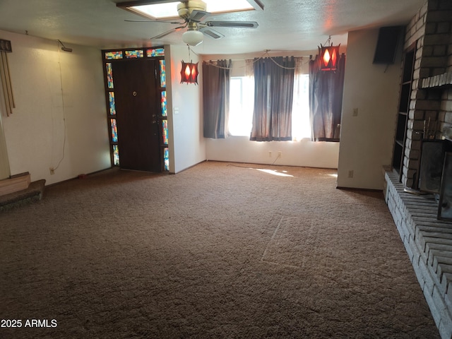5463 E Roberts Dr, Globe, AZ 85501 - unfurnished living room featuring a brick fireplace, ceiling fan, and carpet