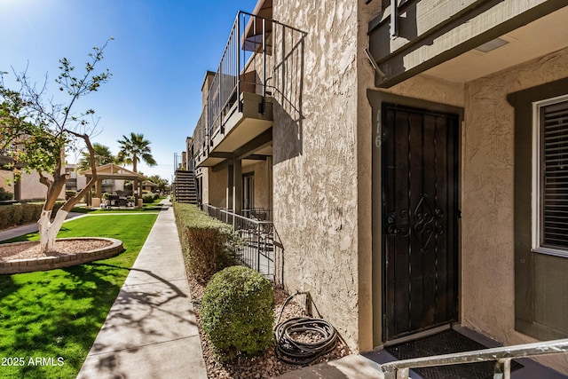 view of exterior entry featuring a yard