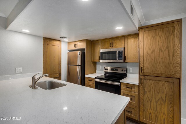 2228 E Campbell Ave Unit 116, Phoenix, AZ 85016 - kitchen with appliances with stainless steel finishes, sink, and kitchen peninsula