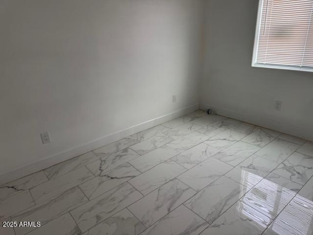 6633 N 54th Dr, Glendale, AZ 85301 - spare room featuring marble finish floor and baseboards