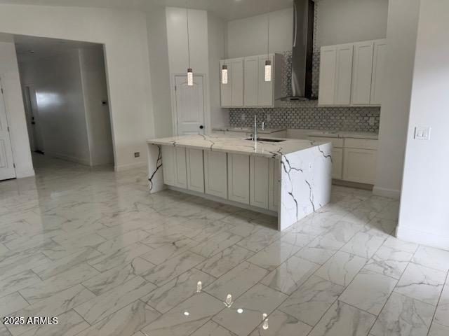 6633 N 54th Dr, Glendale, AZ 85301 - kitchen with marble finish floor, a sink, backsplash, a spacious island, and wall chimney exhaust hood