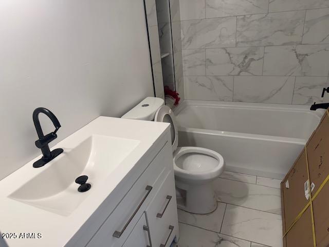 6633 N 54th Dr, Glendale, AZ 85301 - full bathroom featuring vanity, toilet, washtub / shower combination, and marble finish floor