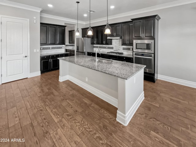 kitchen featuring sink, decorative backsplash, appliances with stainless steel finishes, dark hardwood / wood-style flooring, and light stone countertops