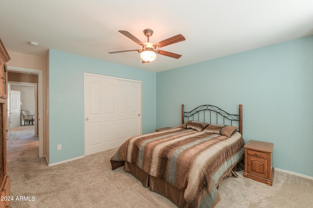 bedroom with ceiling fan, baseboards, and light colored carpet